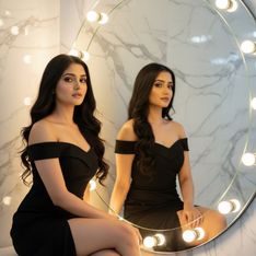 Glamorous Woman in Luxurious Room with Illuminated Mirror